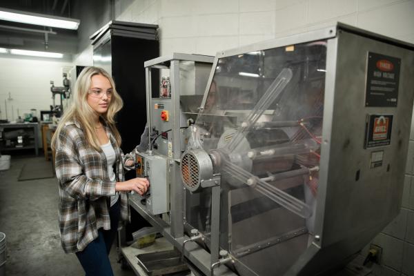 woman in front of sorting machine